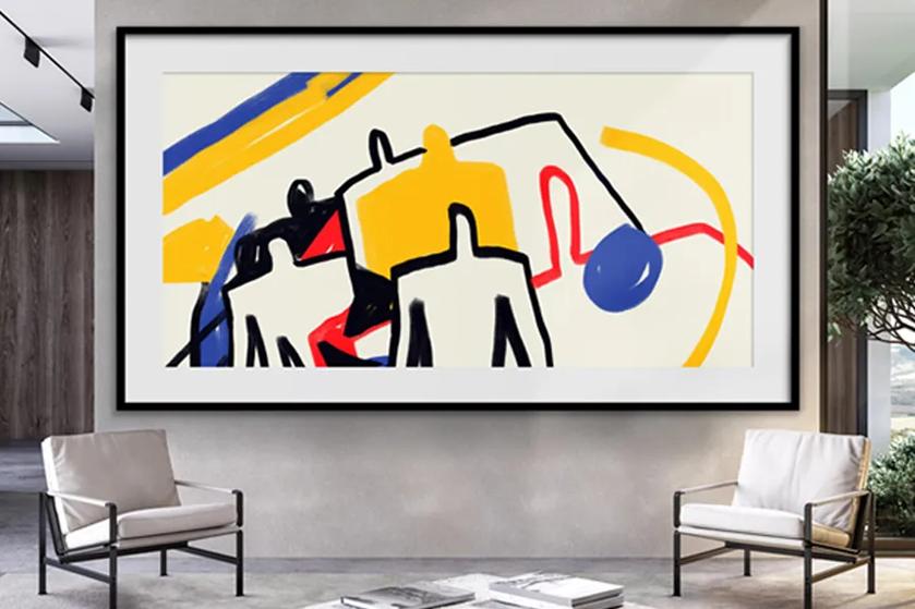 Abstract art on digital display with bold colors in a modern room with armchairs.