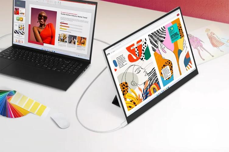 A clean white desk with an LG gram laptop. Attached via cable is an LG plus  View Portable Monitor, adding screen space to the gram. Both displays show bright illustrations. A brightly colored paint chip color wheel rests on the desk in front of the gram laptop.