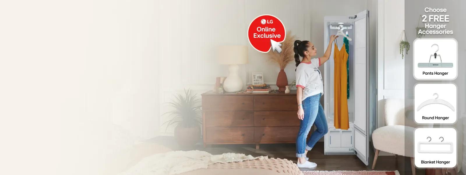LG Styler Steam Closet shown open in a bedroom setting with a woman placing garments inside, featuring LG Online Exclusive badge. Choose 2 FREE Hanger Accessories -- Pants Hanger, Round Hanger, Blanket Hanger.