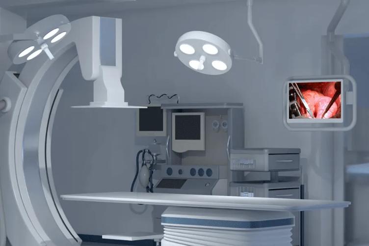 A surgical space with surgical table and various medical tools. Mounted on the wall is an LG surgical monitor with a bright surgery feed displayed on it. 