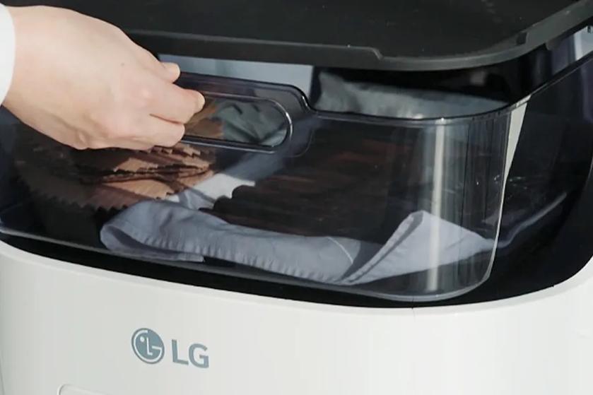 An employee reaches into CLOi robot's convenient storage area to retrieve napkins.
