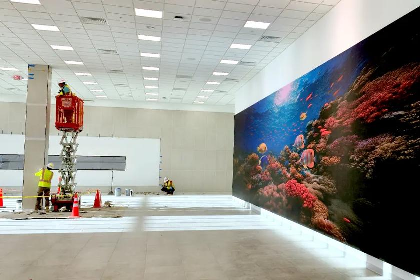 Workers install indoor LG Direct View LED panels