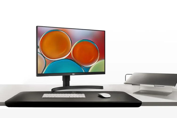 An LG 27BN85UN monitor on a white desk.