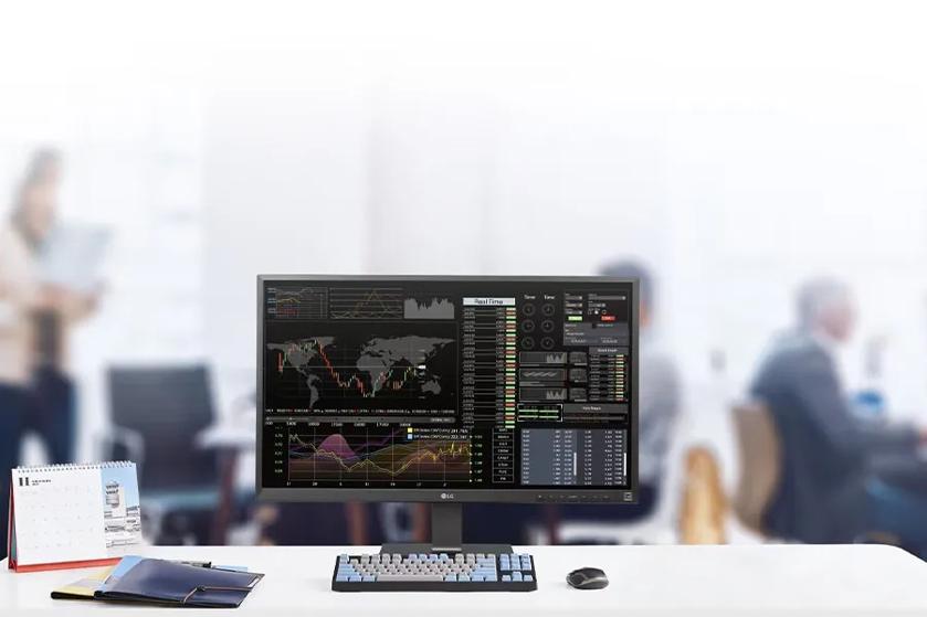 A busy office in the background, with an LG all-in-one cloud client in the foreground.