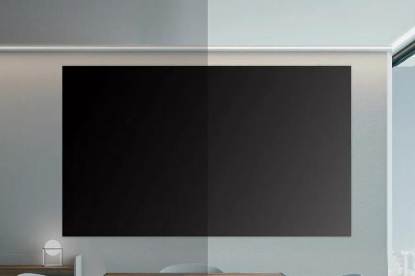 Large black screen on a wall with a vertical light and dark split in a modern room.