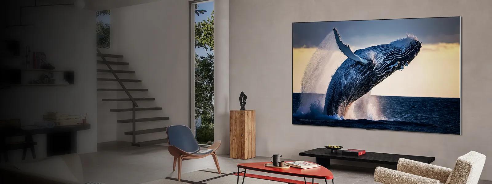 Stylish living room with a wall-mounted LG TV showing a whale leaping from the ocean in vivid detail.