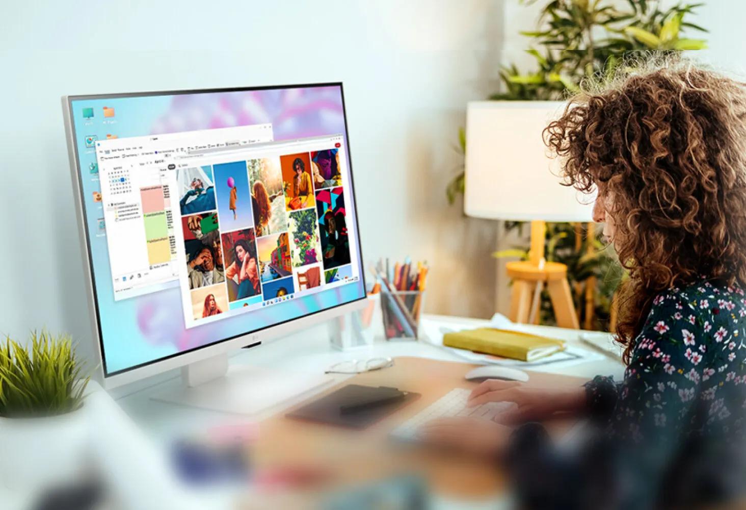 Woman using LG Smart Monitor for productivity with multiple windows open on screen.