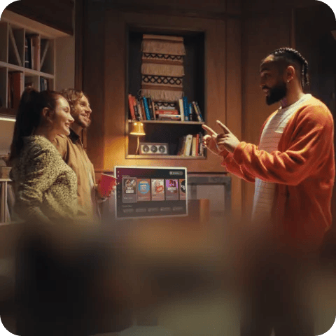Two people playing a motion-controlled dance game on an LG TV in a living room.
