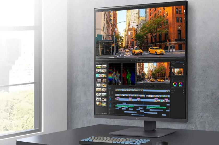 A computer monitor displaying video editing software with a city street scene and a timeline of media clips.