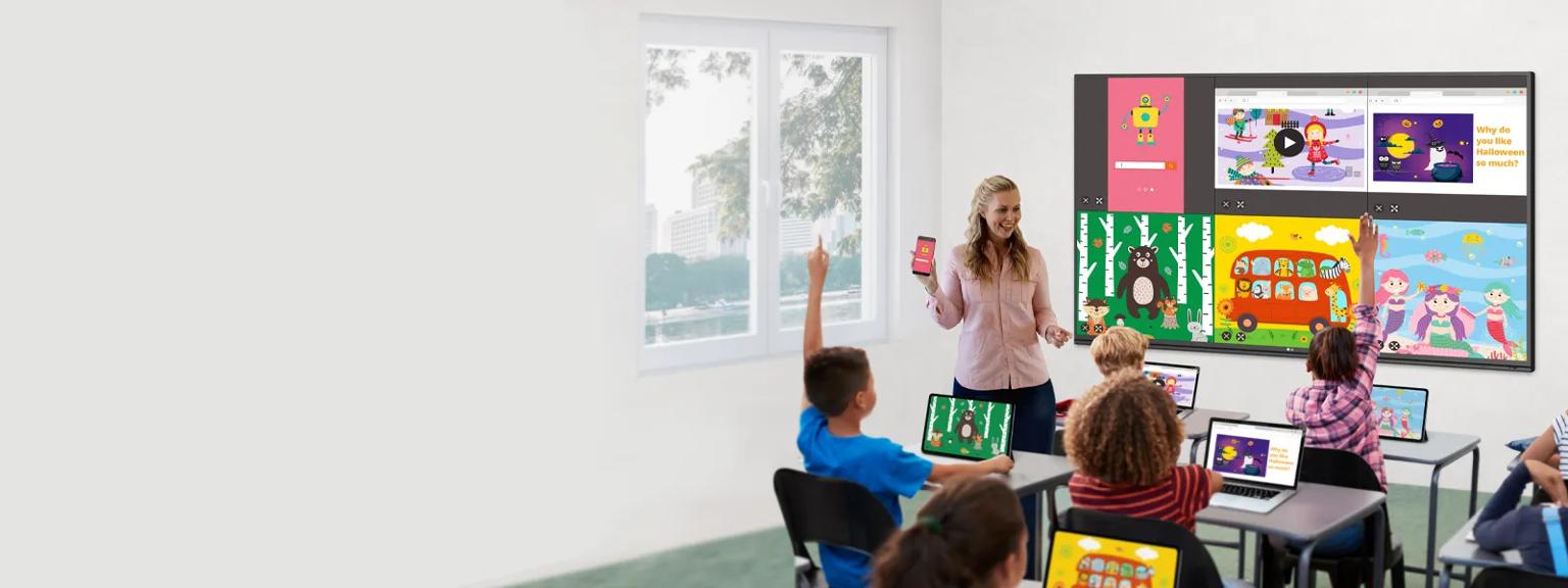 Teacher in classroom uses LG CreateBoard and gram laptops to give a lesson.
