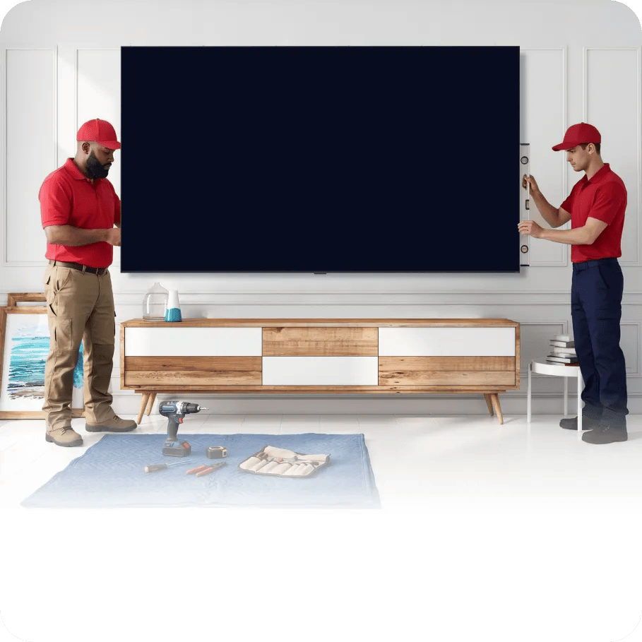 Two installers positioning an LG Big Screen in a bright living room, illustrating professional installation services.