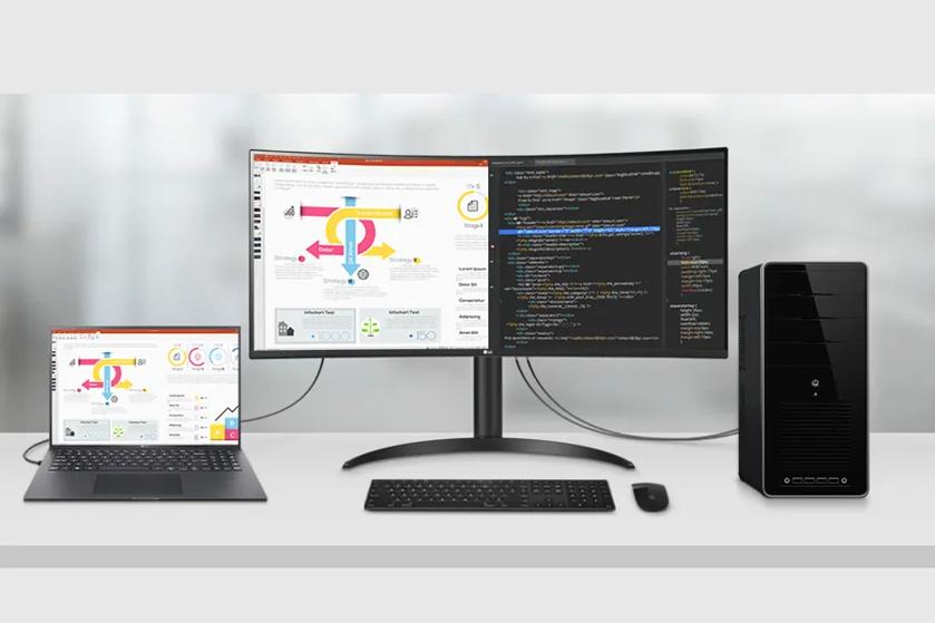 Workspace setup with a laptop, two monitors, desktop tower, keyboard, and mouse on a desk.