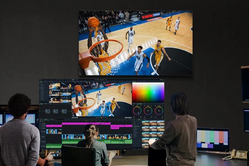 Editing studio with people working on a basketball game video.