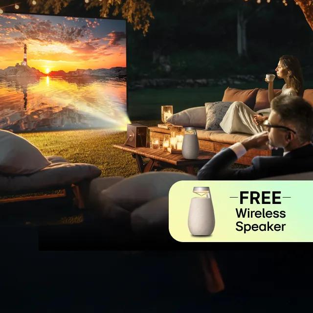 A CineBeam Q projects onto an outdoor screen as a man and woman look on. Pop-out image of a portable speaker with text “FREE Speaker”.
