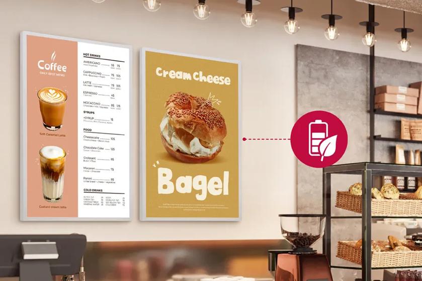 LG e-paper displays in a cafe setting, with an icon of a battery and a leaf. 