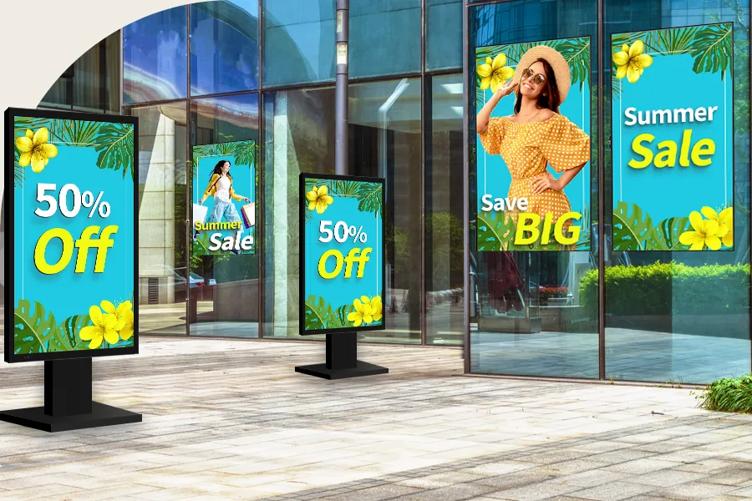 An exterior of a city building. There are three LG Outdoor Digital Signage displays on the windows and two on stands. They all have blue displays with bright colored tropical leaves, flowers, and slogans advertising sales, demonstrating the vivid color and brightness of LG outdoor displays.
