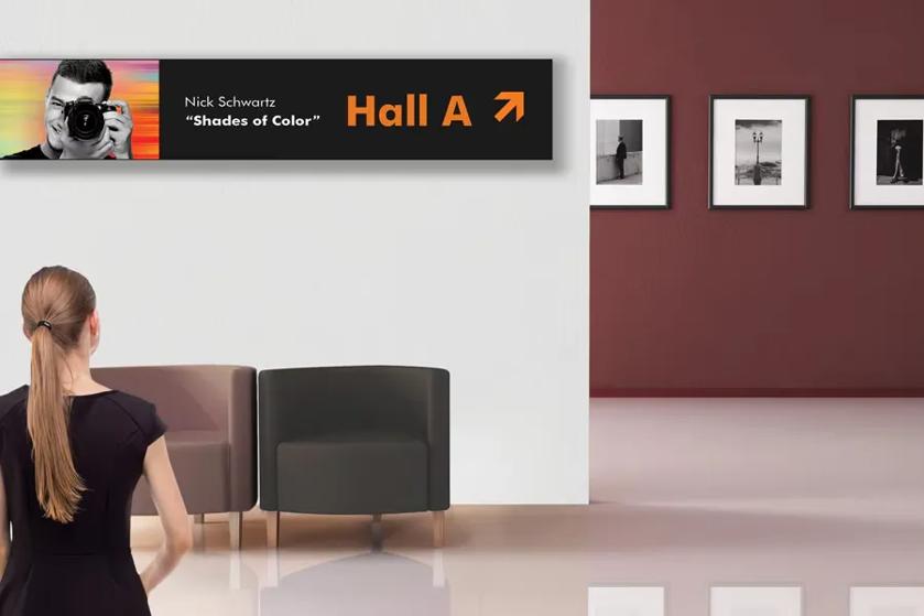 A museum guest looks at LG wayfinding signage.