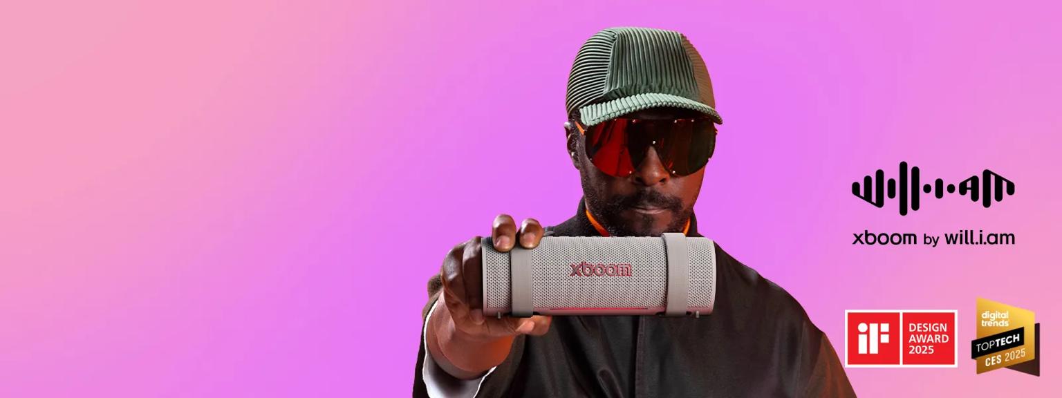 Will.i.am hand holding the xboom Grab in warm grey
