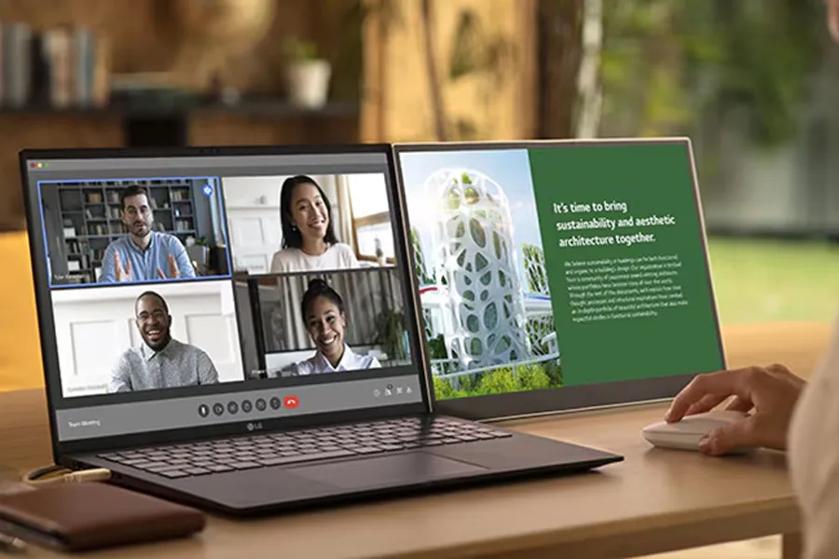 Dual-screen laptop showing a video call on one screen and an architectural presentation on the other.