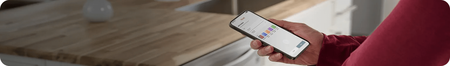 Person holding a smartphone displaying the LG ThinQ app, showing MyColor settings and controls.