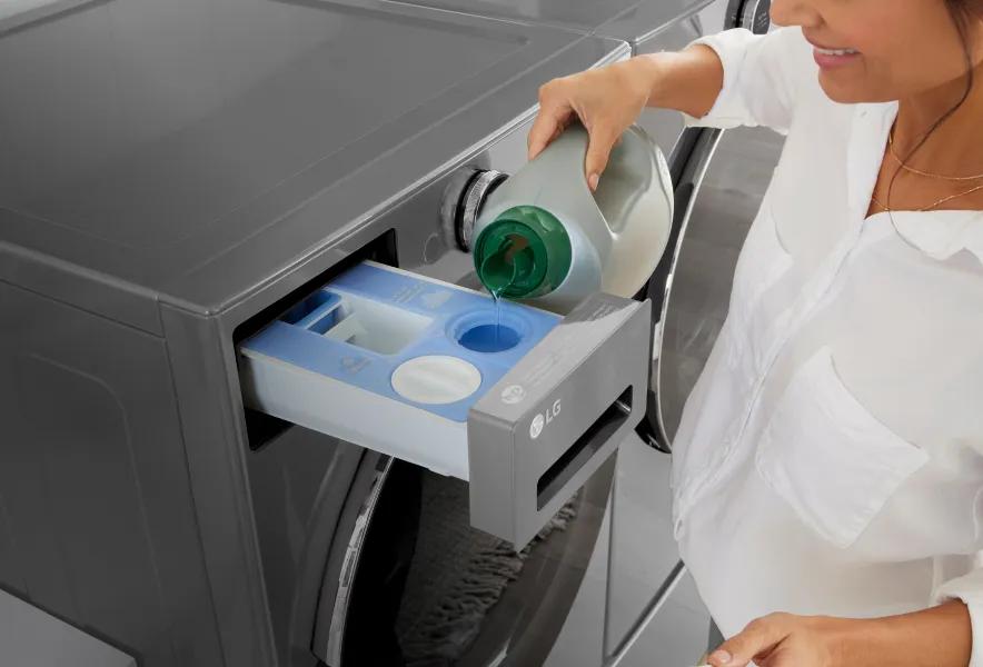 Close-up of woman adding detergent to a front-load washer.