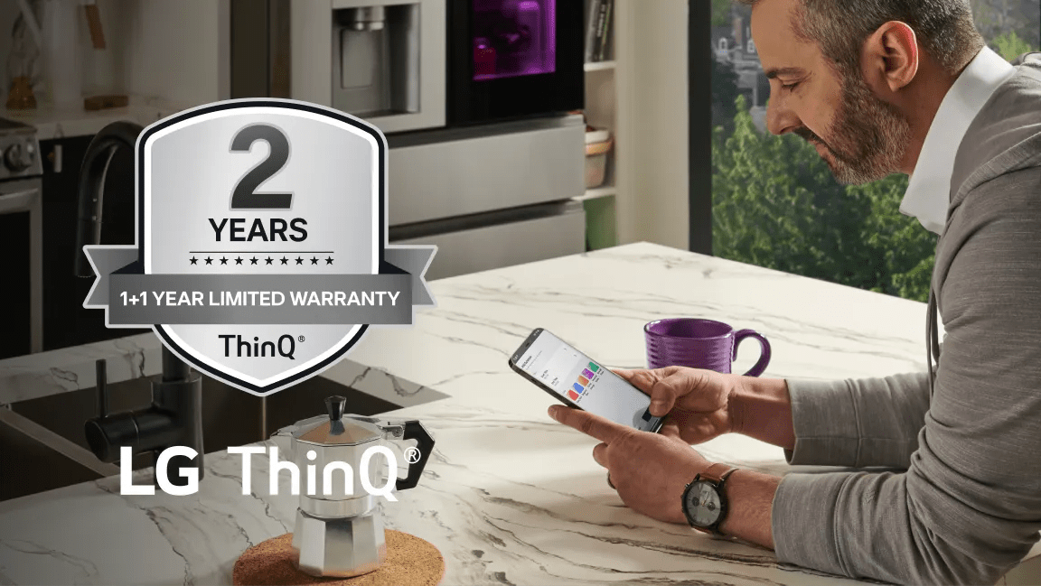 A man scrolls through ThinQ app in his kitchen. “2 Years ThinQ: 1+1 Year Limited Warranty” badge.