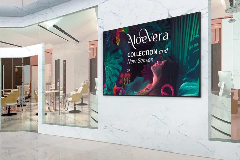 Interior of a modern space with a colorful tropical-themed advertisement on the wall.