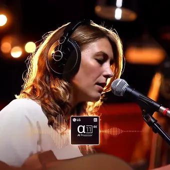 Woman singing into microphone with headphones, highlighted by LG α11 AI Processor sound enhancement.