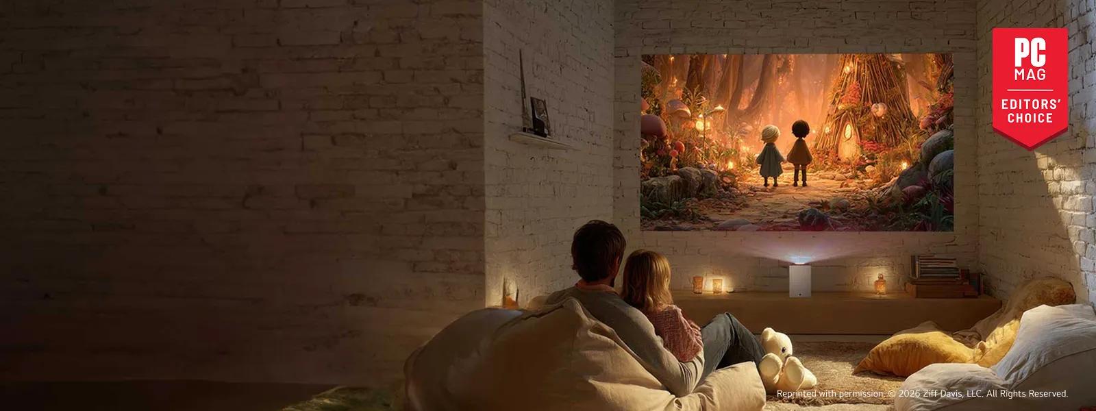 A couple sitting on a couch watching an animated movie projected on a wall by an LG CineBeam S projector in a cozy living room with white exposed brick walls. A red badge reading “PC Mag Editors’ Choice” is in the corner.