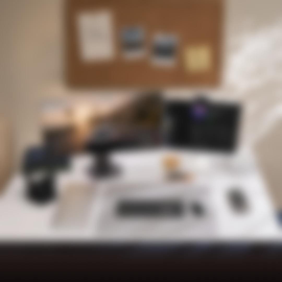 Two LG monitors on a desk displaying a racing game and music app, with keyboard, mouse, headphones, laptop, and books, cork board above with notes reading Focus on consistency, not motivation and Plan Prepare Perform