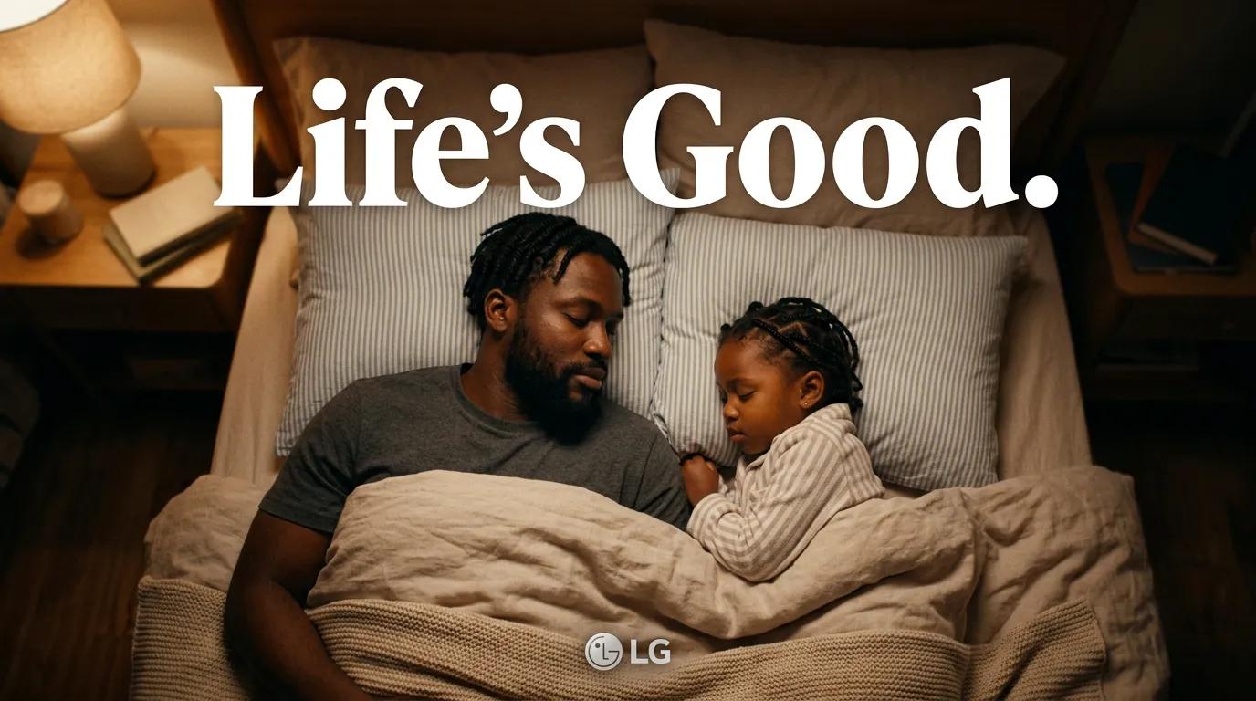 An overhead view of a father and his young daughter sleeping side by side in bed under a beige blanket, lit by a warm bedside lamp, with the text 'Life's Good.' and the LG logo.