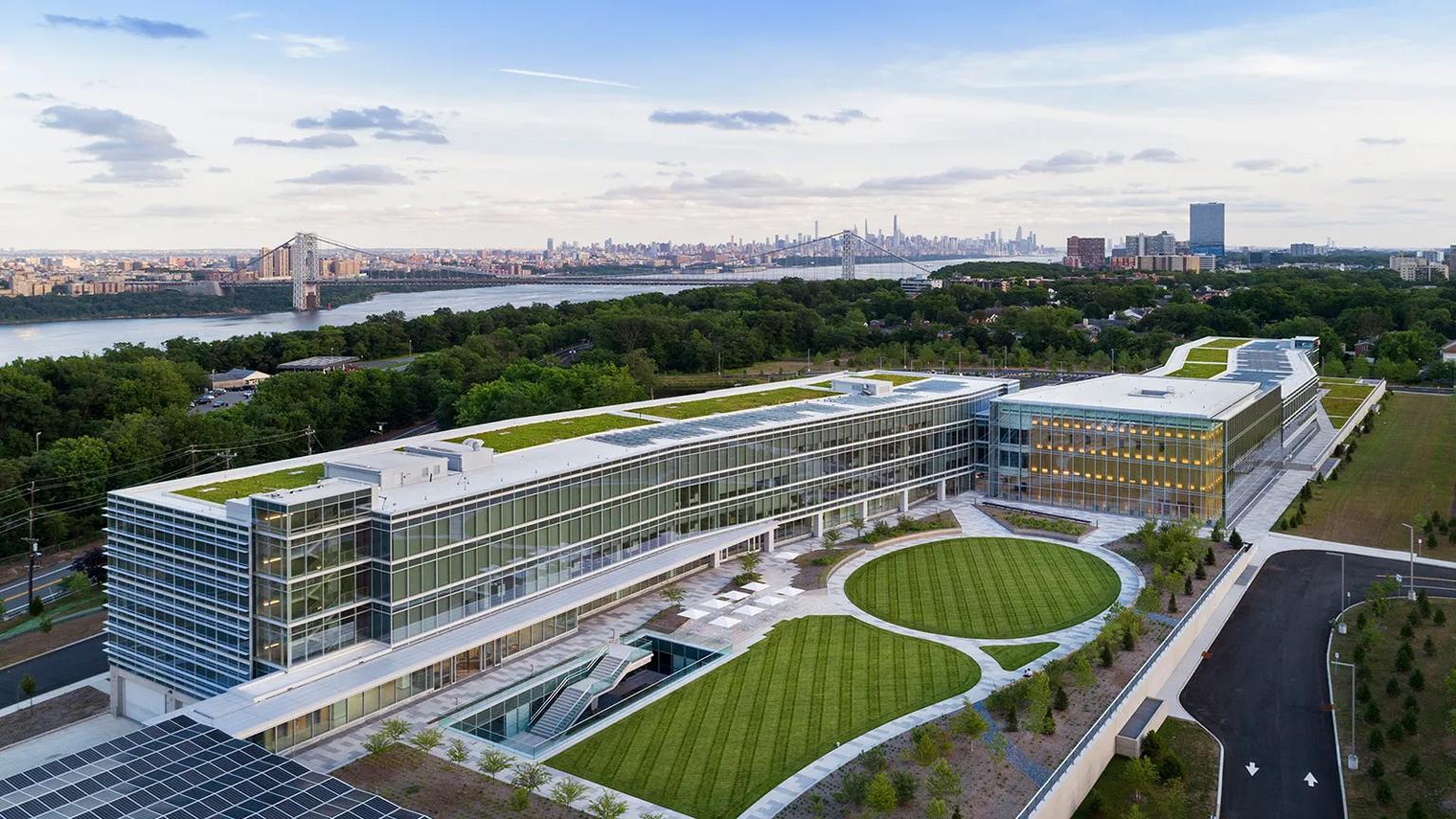 Aerial view of LG North America headquarters campus with green rooftop, landscaped grounds, and New York City skyline in background