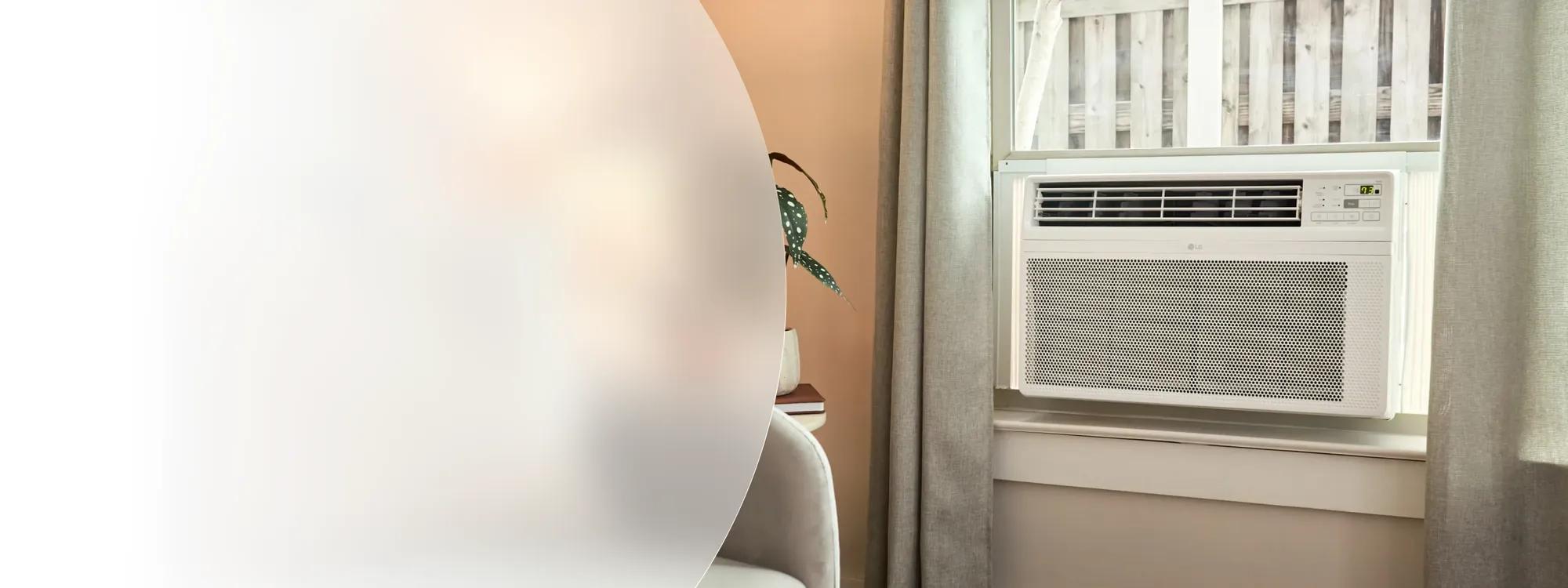 Labor Day Savings -- LG window air conditioner installed in a room window beside a chair and decorative plant