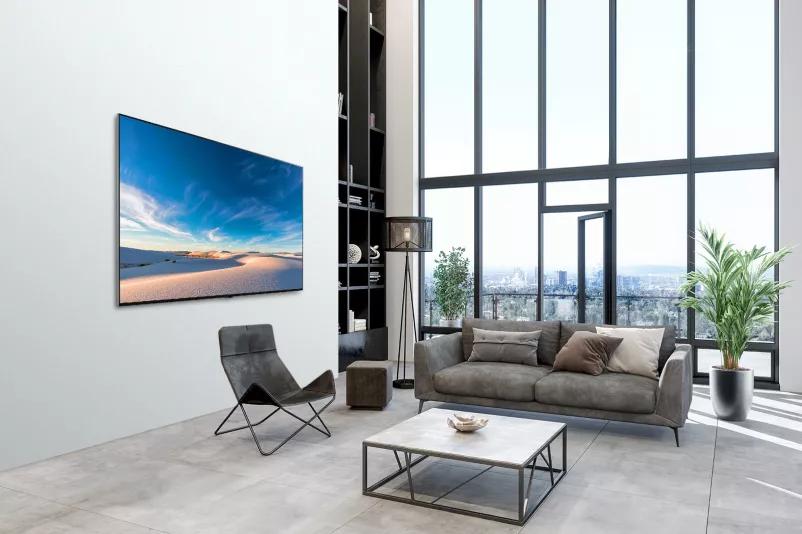 LG QNED TV mounted flat against the wall in a modern interior space