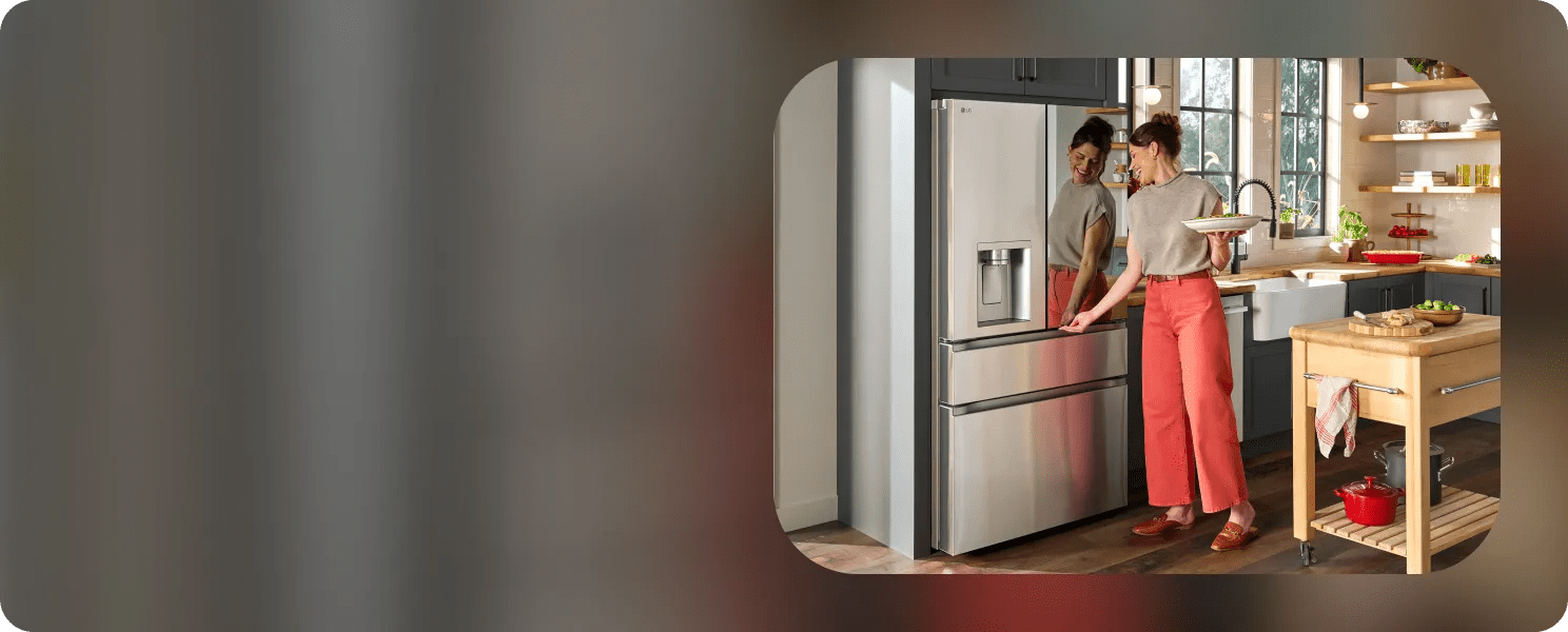 Front view of an installed LG 4-Door French door refrigerator with Mirror InstaView reflecting a woman opening it while holding a salad plate in a bright kitchen.