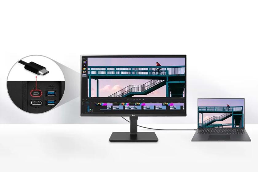 A desktop monitor and laptop connected via USB-C cable, displaying mirrored content.