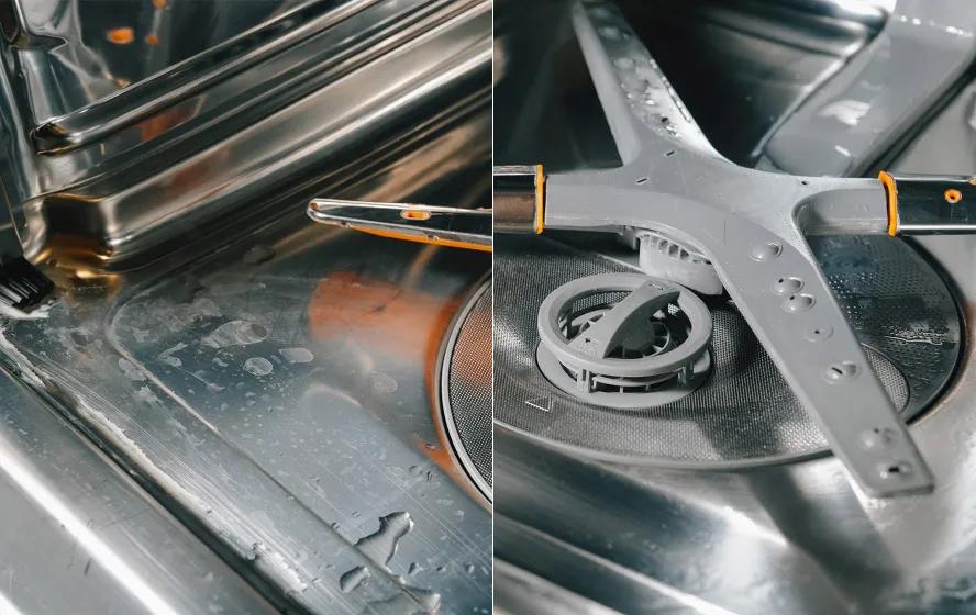 The interior floor of an LG dishwasher is covered in food debris and hard water stains.