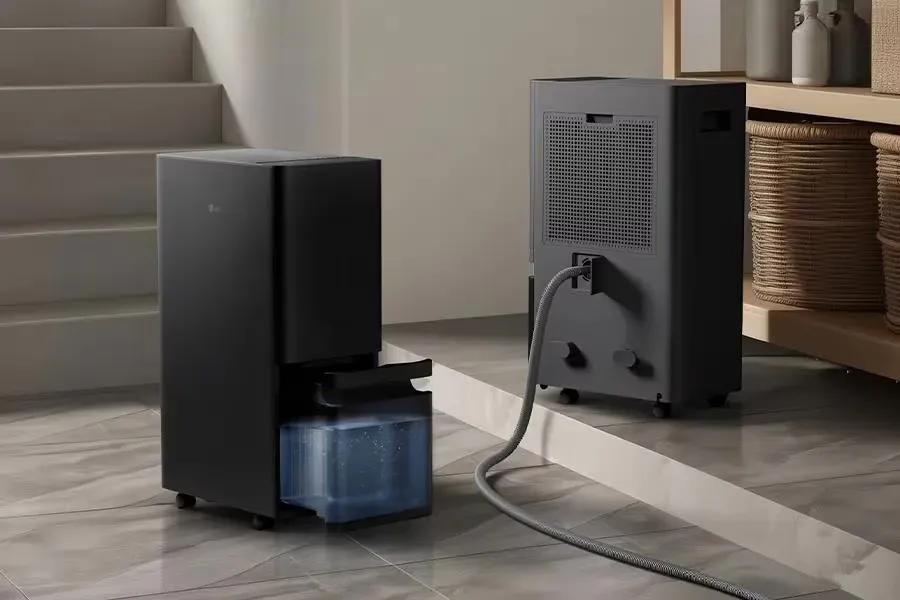 DT501BKR0 LG Dehumidifier with automatic drying feature showing water tank and drainage hose connection