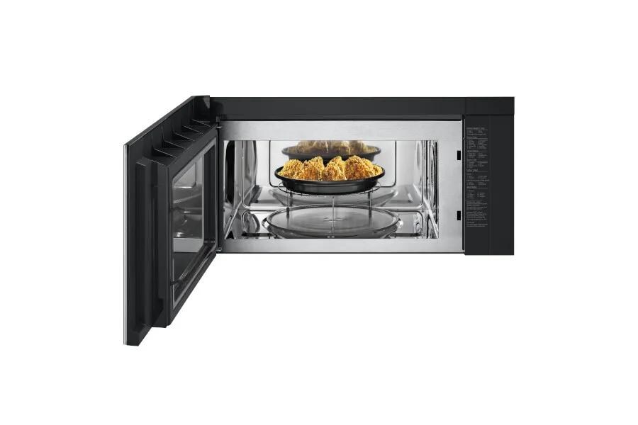 MHEU1738X Over-the-Range Microwave with door open showing crispy fried chicken on elevated rack for even cooking