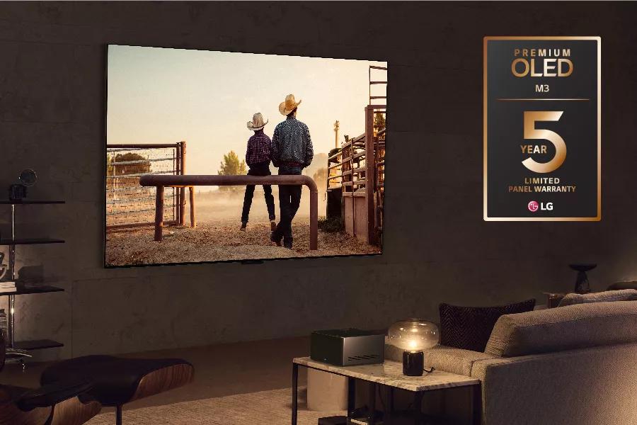A western plays on the TV. Premium OLED M3 5 year limited warranty logo.