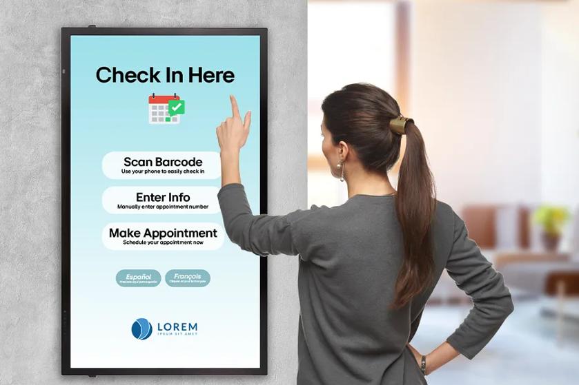 A woman checks into her appointment using LG touch signage