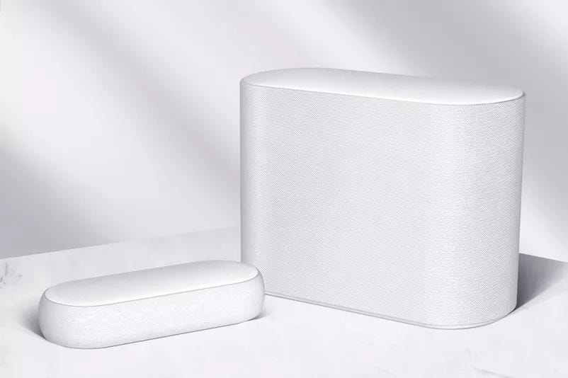 LG Eclair and subwoofer are placed on a white marble floor slightly tilted