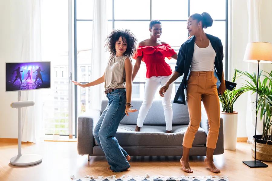Image of women dancing and listening to music in the living room on the the XT7S StanbyMe Speaker 