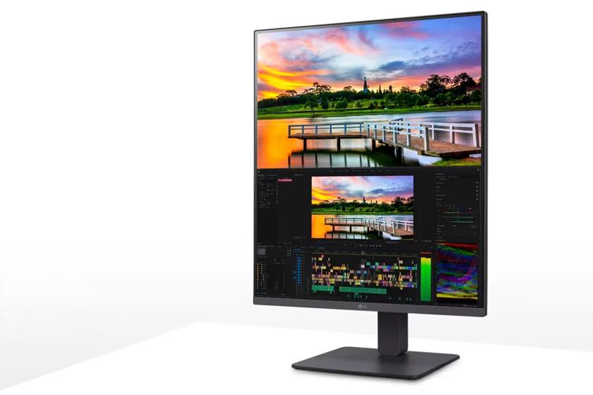 A vertical computer monitor displaying a sunset photo and video editing software.