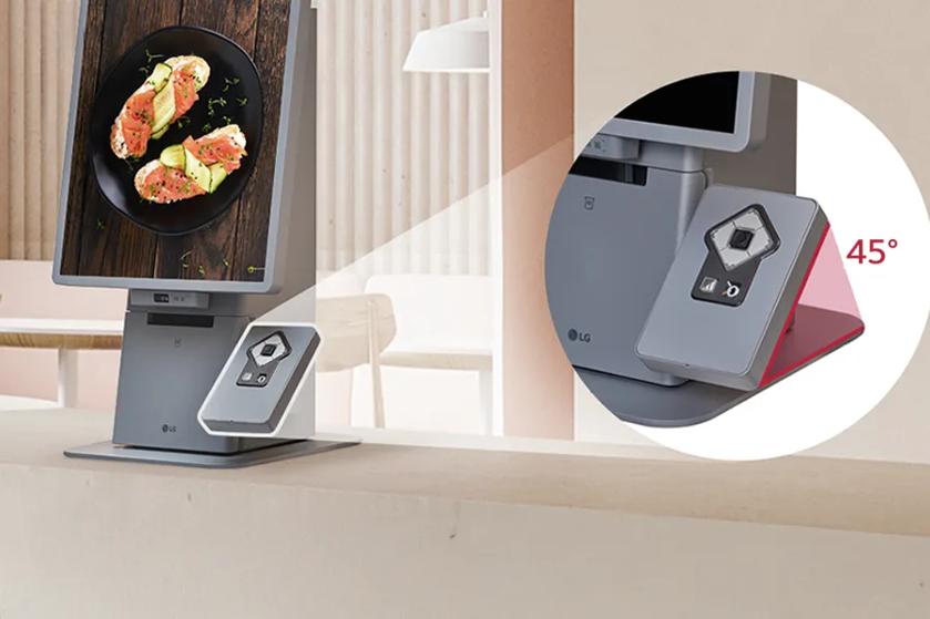 A monitor in vertical orientation on a table, showing a plate of food, with an inset highlighting its adjustable 45-degree hinge.