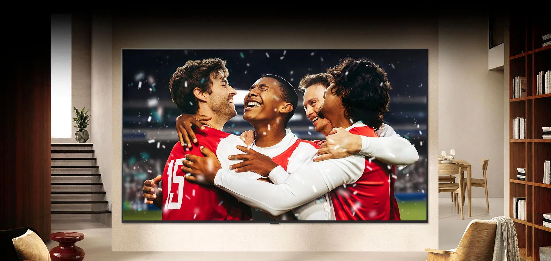 LG TV wall-mounted in a bright living room shows a stadium sports celebration with vivid colors and refined picture quality on a wide screen.