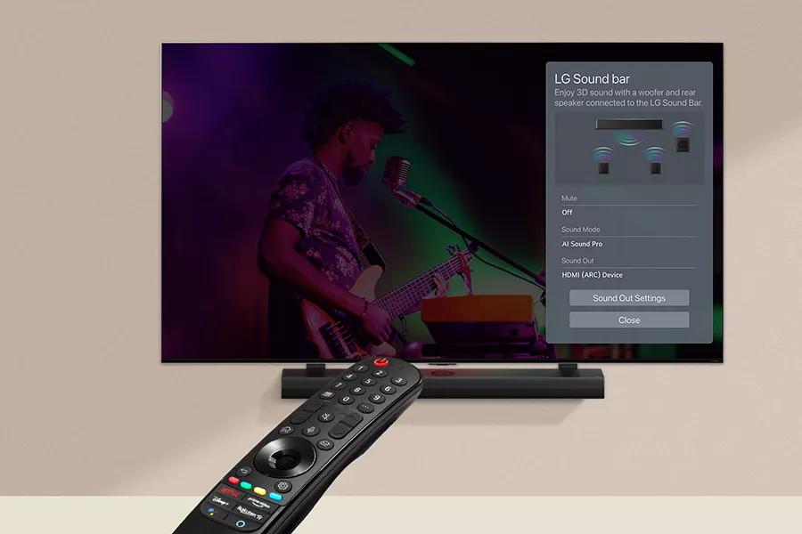 A remote pointed at the LG LR65 screen, featuring the LG Soundbar settings interface, with the soundbar underneath.