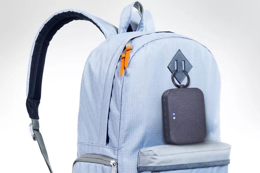 LG XBOOM Go PN1 is clipped onto the sky blue colored backpack