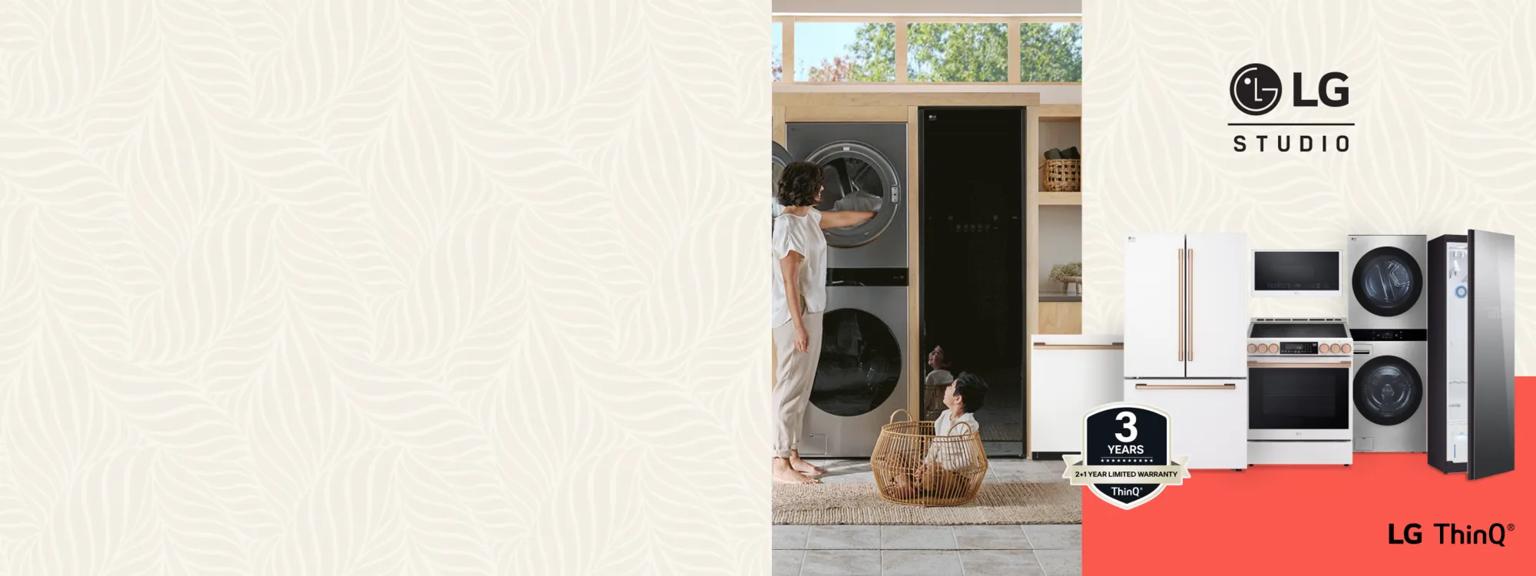 A woman removes laundry from an LG WashTower as her child looks on, sitting playfully inside of a laundry basket. Aside the image is a lineup of LG STUDIO appliances, including a Styler Steam closet, WashTower, range, microwave, refrigerator and dishwasher. A badge for “ThinQ 2+1 Year Limited Warranty appears” between the two images and the LG STUDIO logo appears on the upper right. 