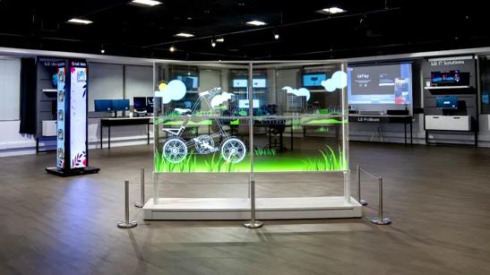 Interior of the LG Business Innovation Center in Chicago, with a transparent signage display in the center of the image. In the background are other LG solutions such as other signage solutions and projectors.